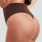 Close up of woman's body posing in brown high-waisted shapewear underwear showing the side view of the thong design and the high-waisted tummy and waist control shaping..