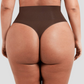 Close up of woman from the behind wearing brown shapewear underwear with a high-waisted thong design and body-contouring tummy and waist control.
