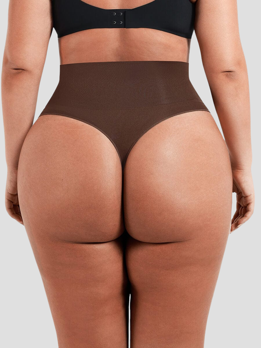 Close up of woman from the behind wearing brown shapewear underwear with a high-waisted thong design and body-contouring tummy and waist control.