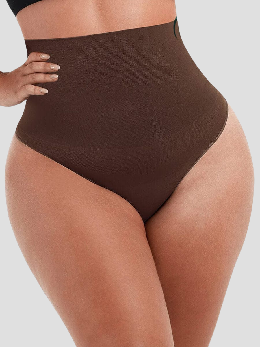 Close up of woman's waist wearing brown high-waisted shapewear underwear with body-contouring tummy and waist control.