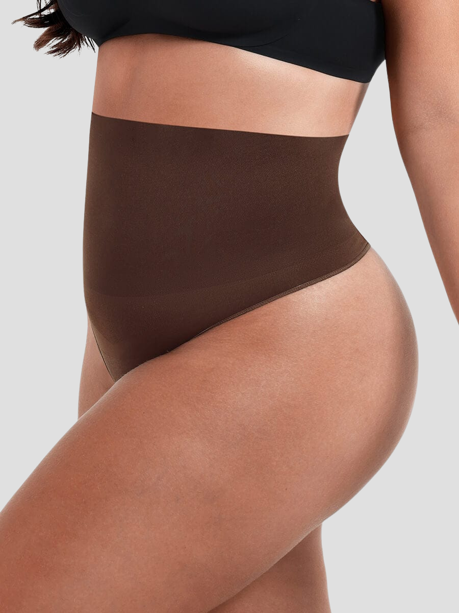 Close up of woman's waist wearing brown high-waisted shapewear underwear with body-contouring tummy and waist control.