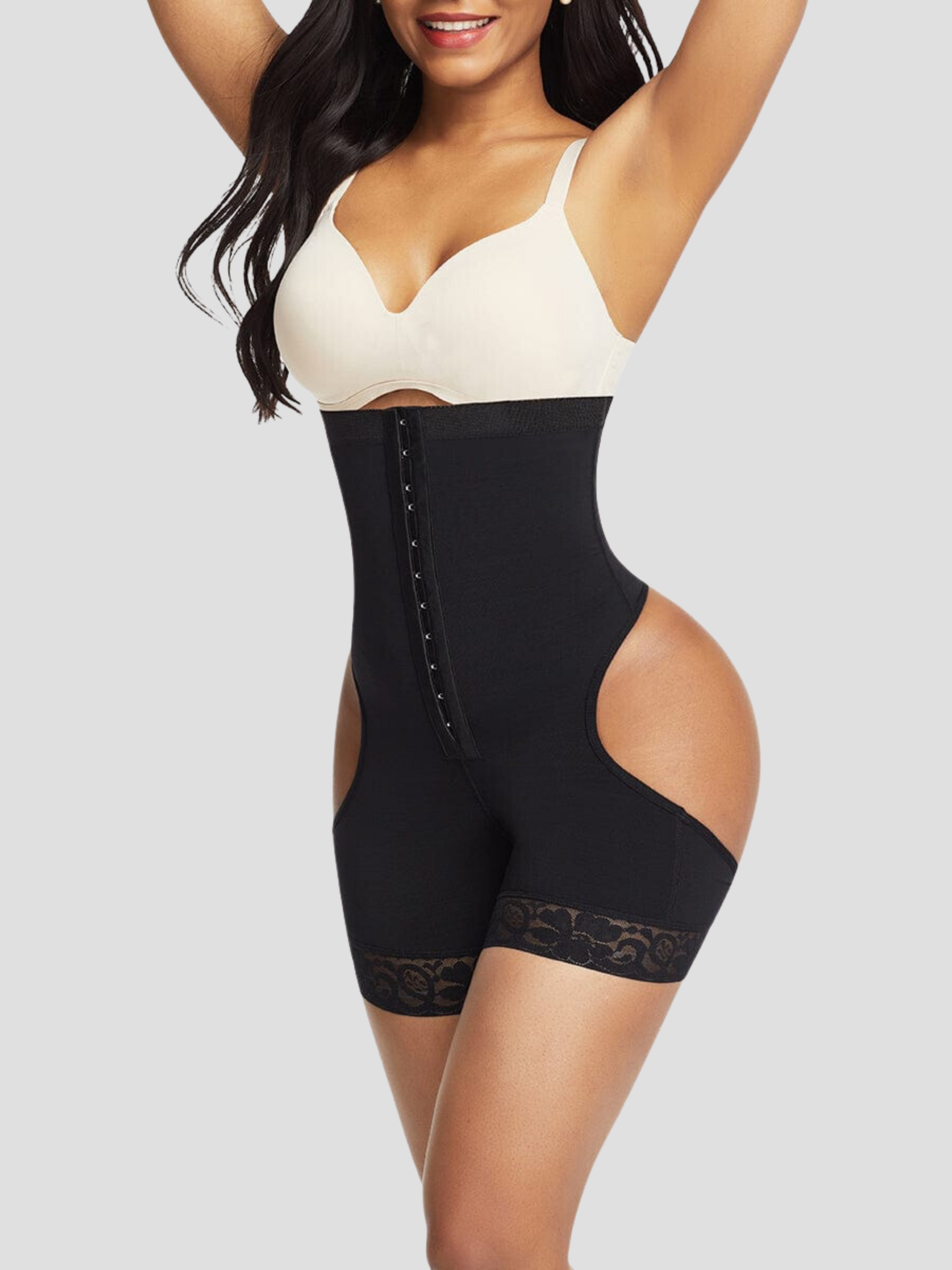 Woman wearing a black mid-thigh open hip faja corset shapewear garment by BodyFlexx.