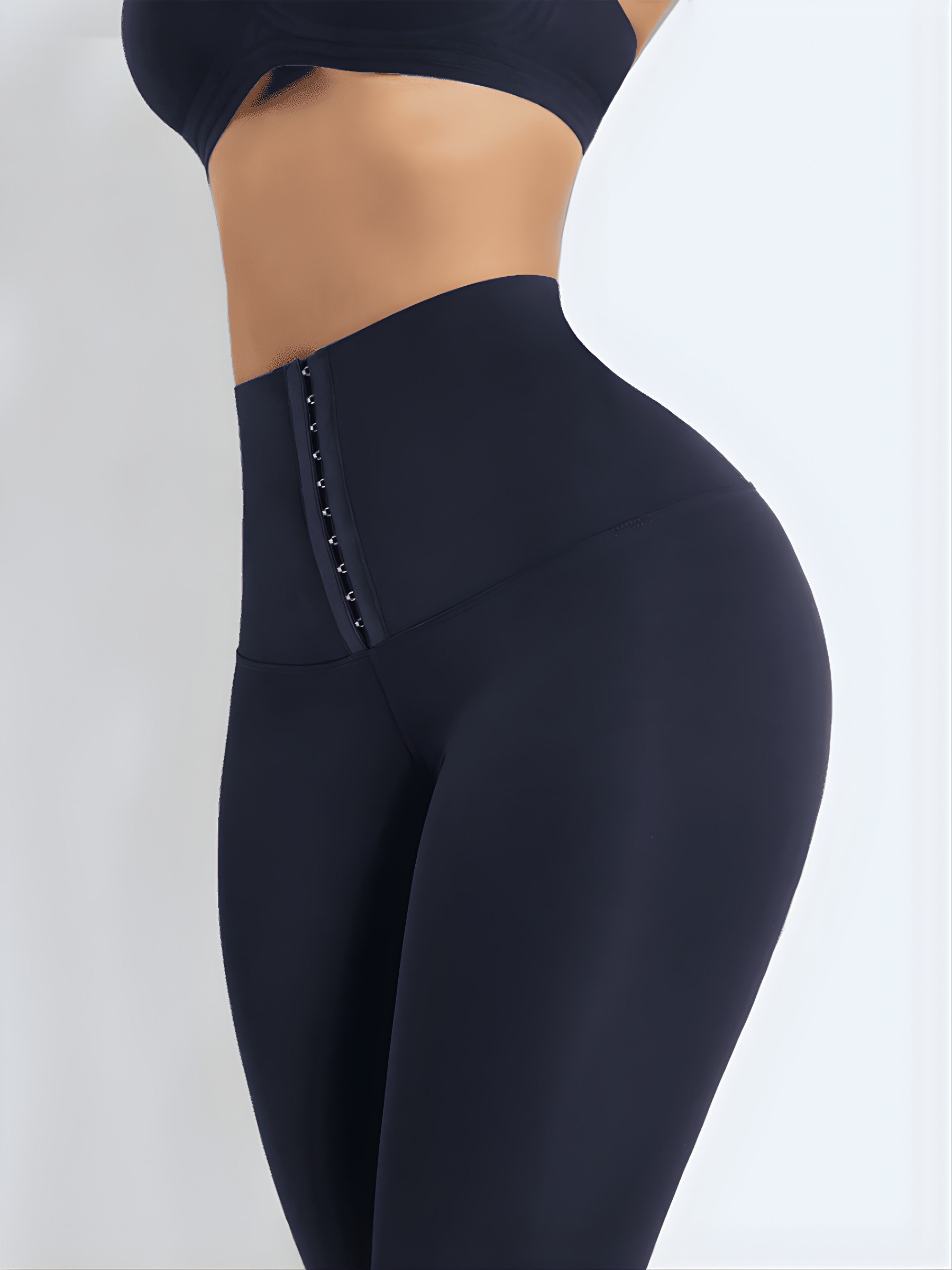 Close up of the a woman's waist wearing high waisted blue waist training leggings with a 3 row hook-and-eye corset closure by BodyFlexx Shapewear.