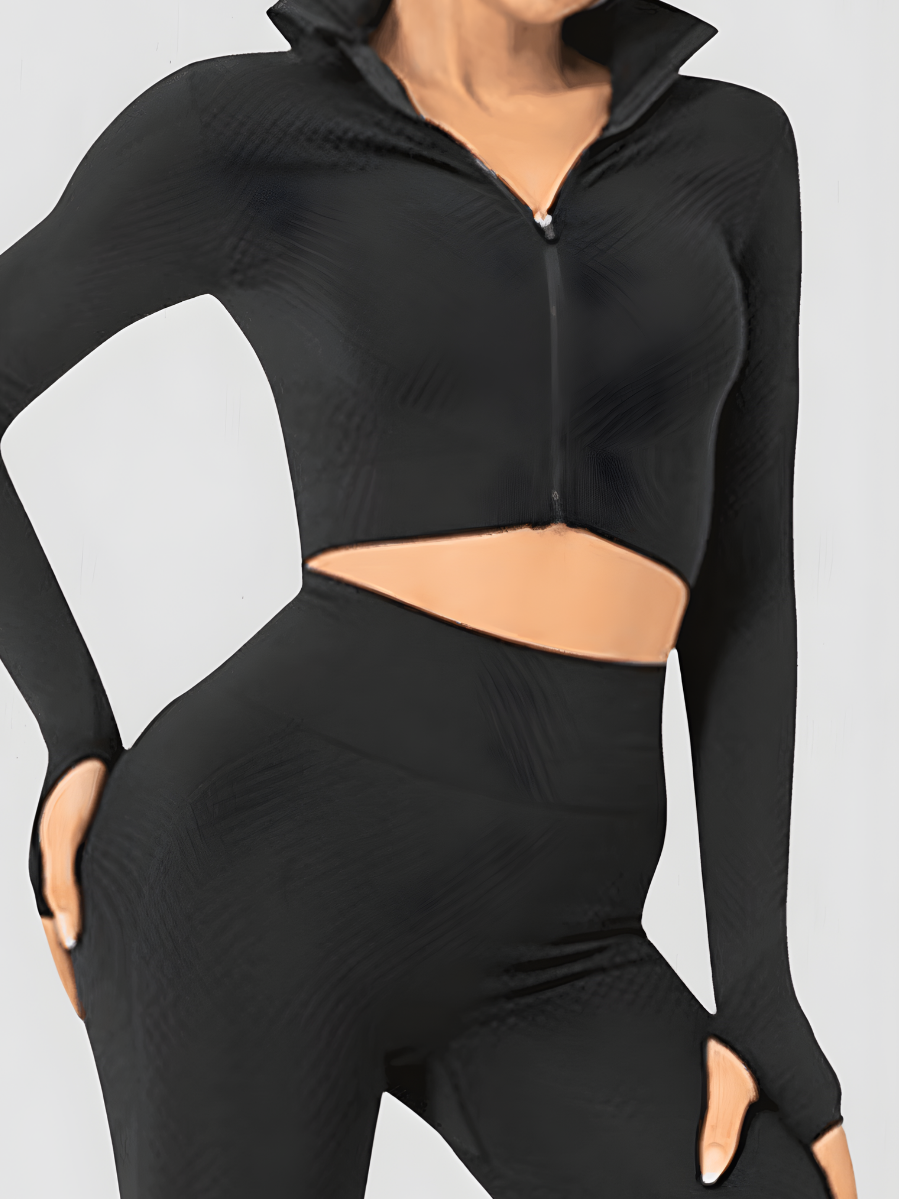 Fitness model posing in a black zippered cropped activewear BBL jacket with matching leggings.