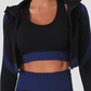 Woman wearing a blue and black zippered cropped a BBL jacket with a matching activewear top.