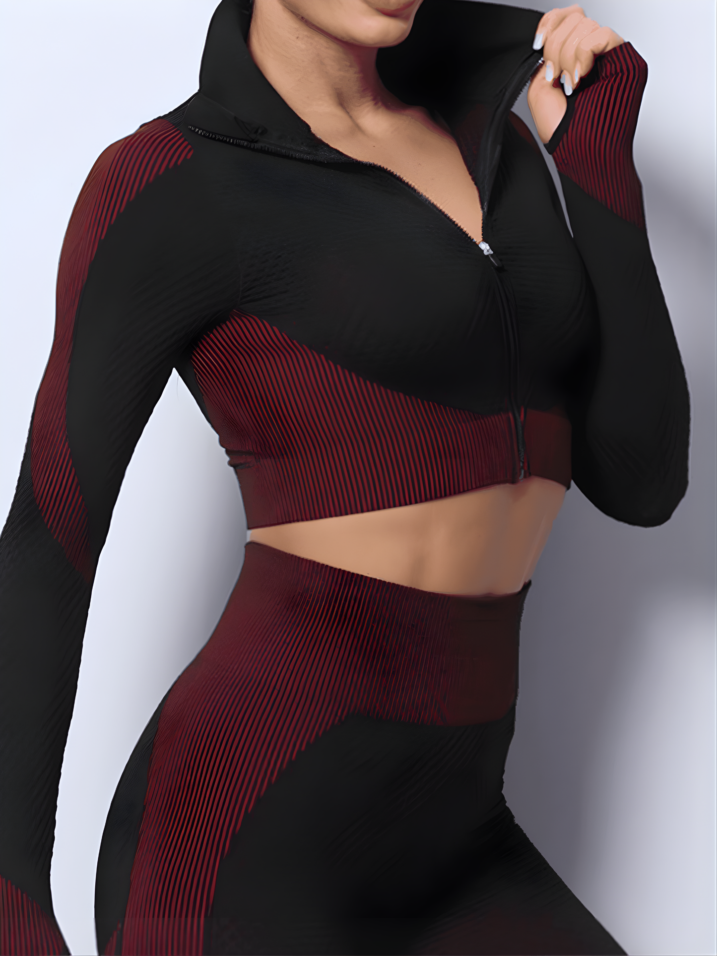 Woman wearing a fuchsia and black zippered cropped activewear BBL jacket with matching leggings by BodyFlexx.