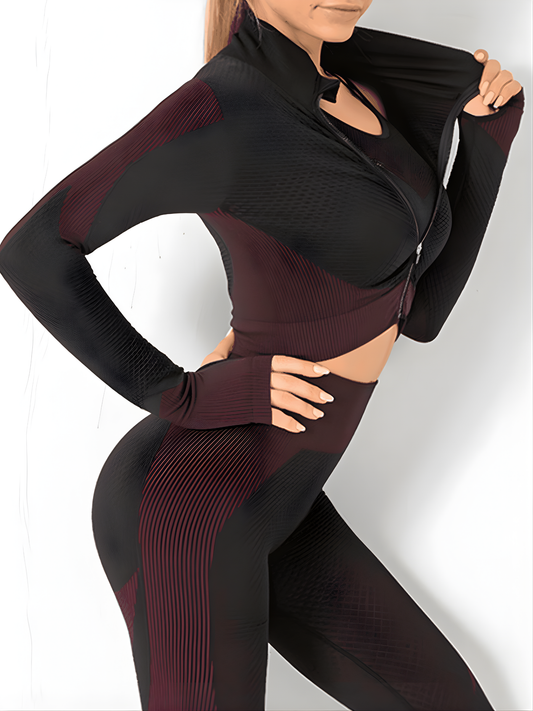 Woman wearing a fuchsia and black zippered cropped activewear BBL jacket with matching leggings.