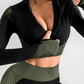 Woman in a green and black zippered cropped activewear BBL jacket with matching leggings.