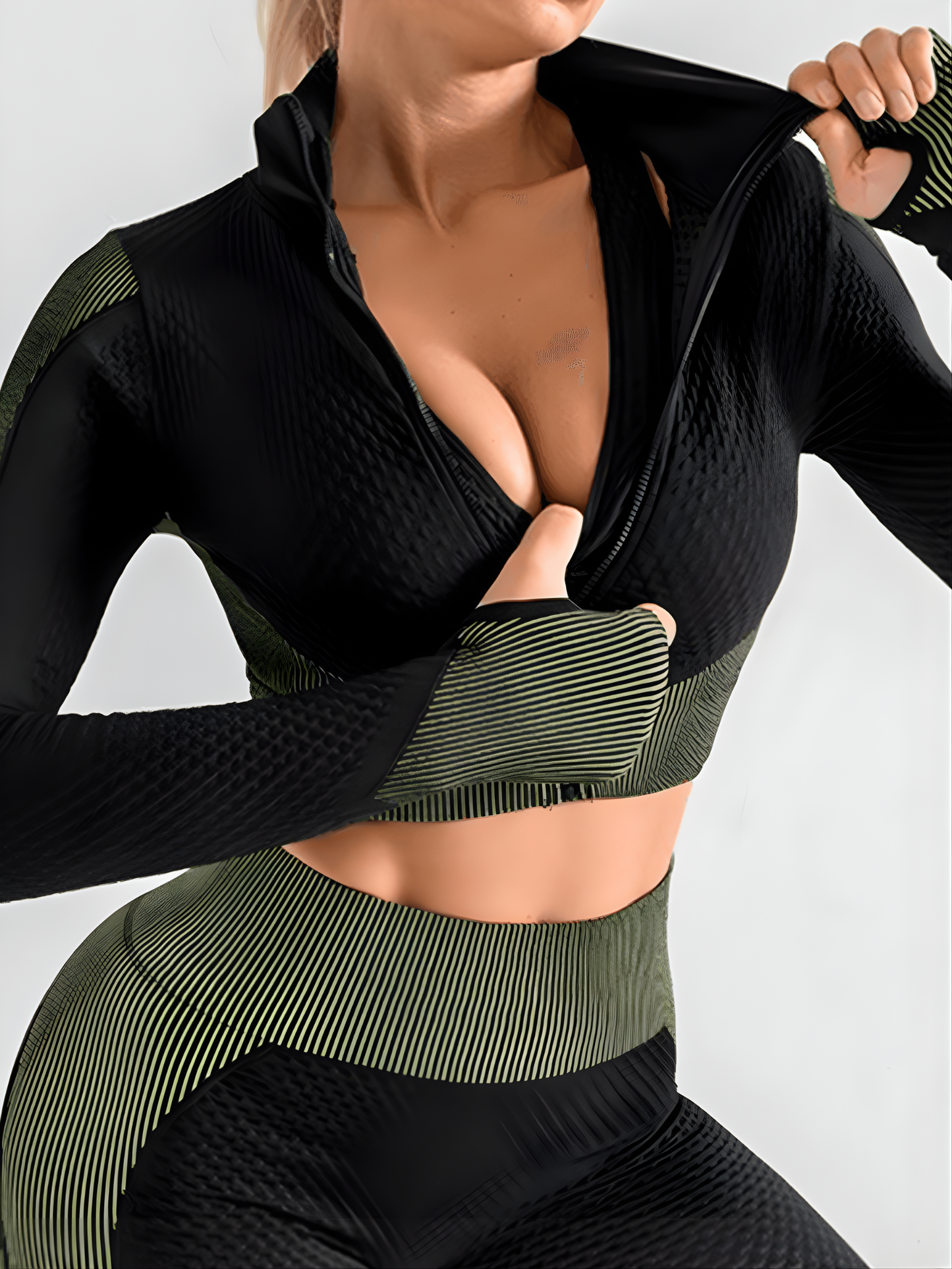 Woman in a green and black zippered cropped activewear BBL jacket with matching leggings.