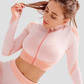 Woman wearing a pink zippered cropped activewear BBL jacket designed by BodyFlexx.