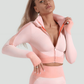 Woman wearing a pink zippered cropped activewear BBL jacket with matching leggings.