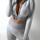 Woman wearing a silver gray zippered cropped activewear BBL jacket by BodyFlexx.