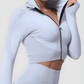 Woman wearing a silver gray zippered cropped activewear BBL jacket by BodyFlexx.