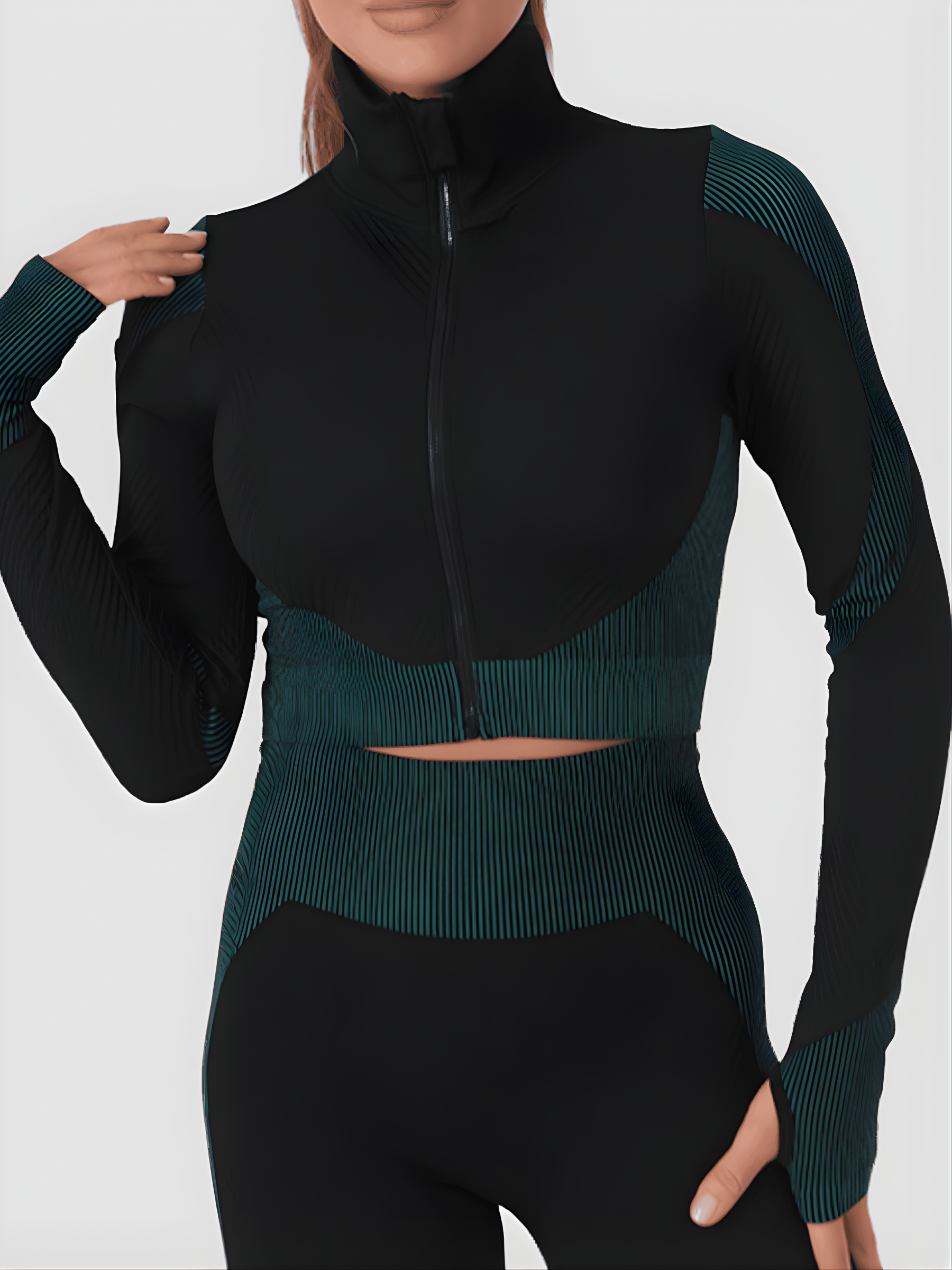 Woman wearing a teal and black zippered cropped activewear BBL jacket with matching leggings.