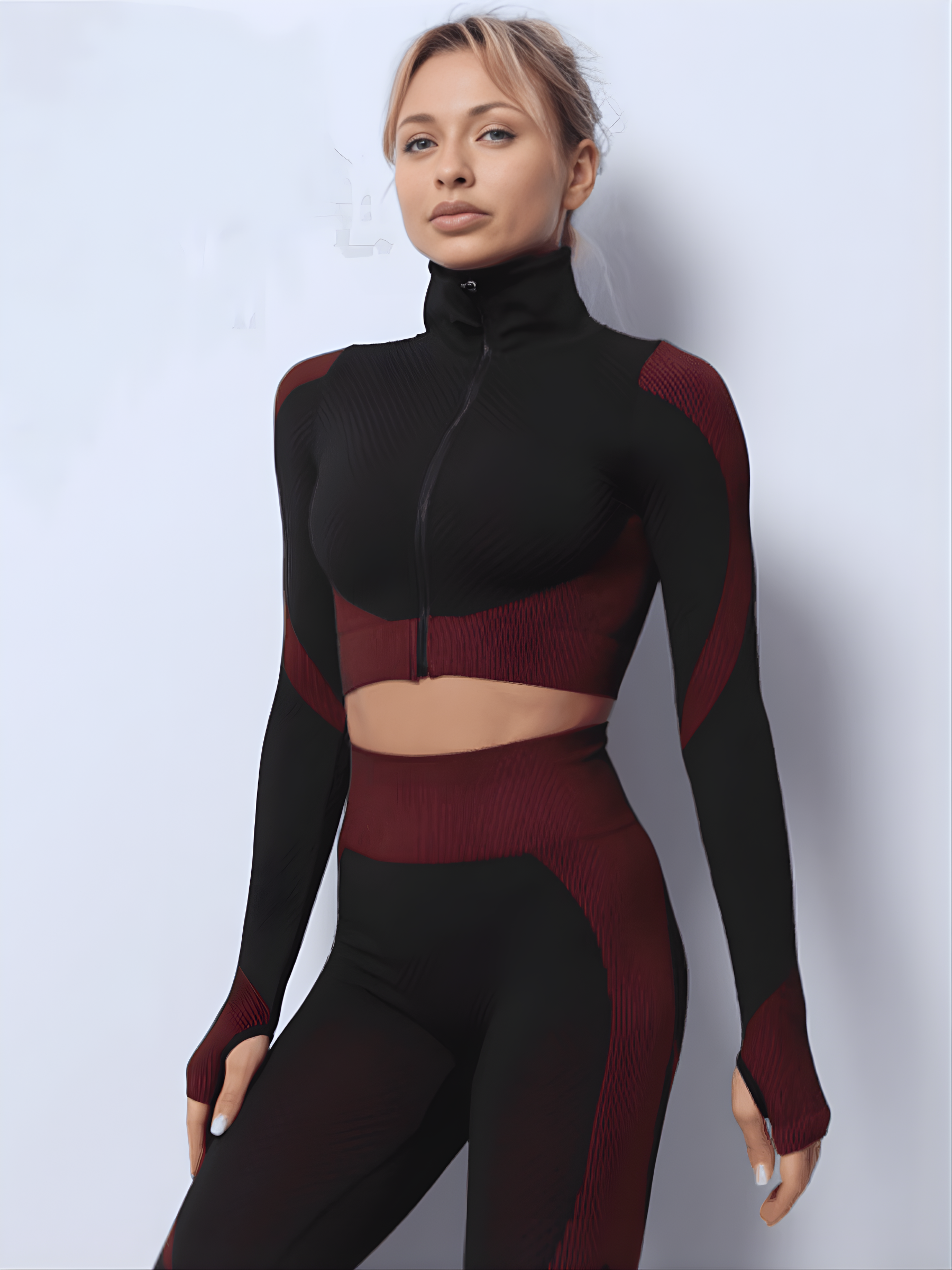 Fitness model wearing a fuchsia and black zippered cropped activewear BBL jacket with matching leggings.