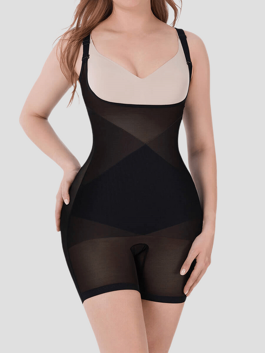 Woman wearing an open chest bodysuit shapewear with her hand on her leg showing the thigh-toning and waist-cinching. Shaper is by BodyFlexx.