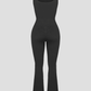 Full length black shaping jumpsuit romper with built-in shapewear and a flared leg design.