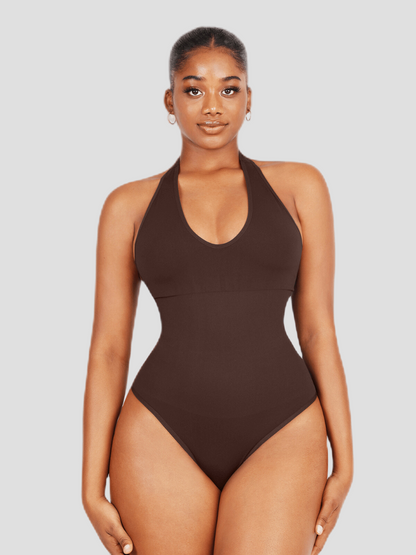 Woman wearing a brown halter-style shapewear bodysuit with built-in removable bra padding and seamless thong design.