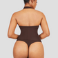 Woman wearing a black halter-style shapewear bodysuit with built-in removable bra padding and a seamless thong design.