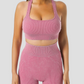 Woman wearing ribbed high-waisted pink activewear shorts and a matching sports bra designed by BodyFlexx.