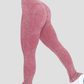 Woman wearing high-waisted ribbed pink leggings with a stylish bottom zipper on each leg.