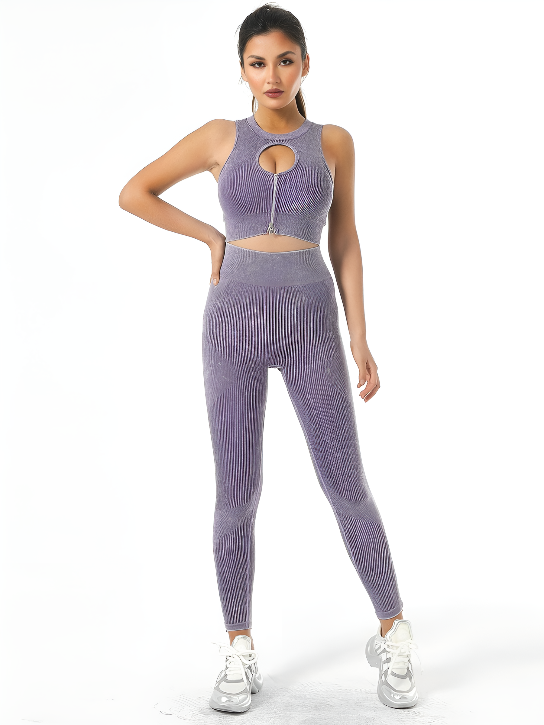 Woman wearing high-waisted ribbed pink leggings with a matching sports bra designed by BodyFlexx.