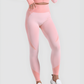 Woman wearing high waisted pink patterned color block leggings with a matching athletic jacket by BodyFlexx.