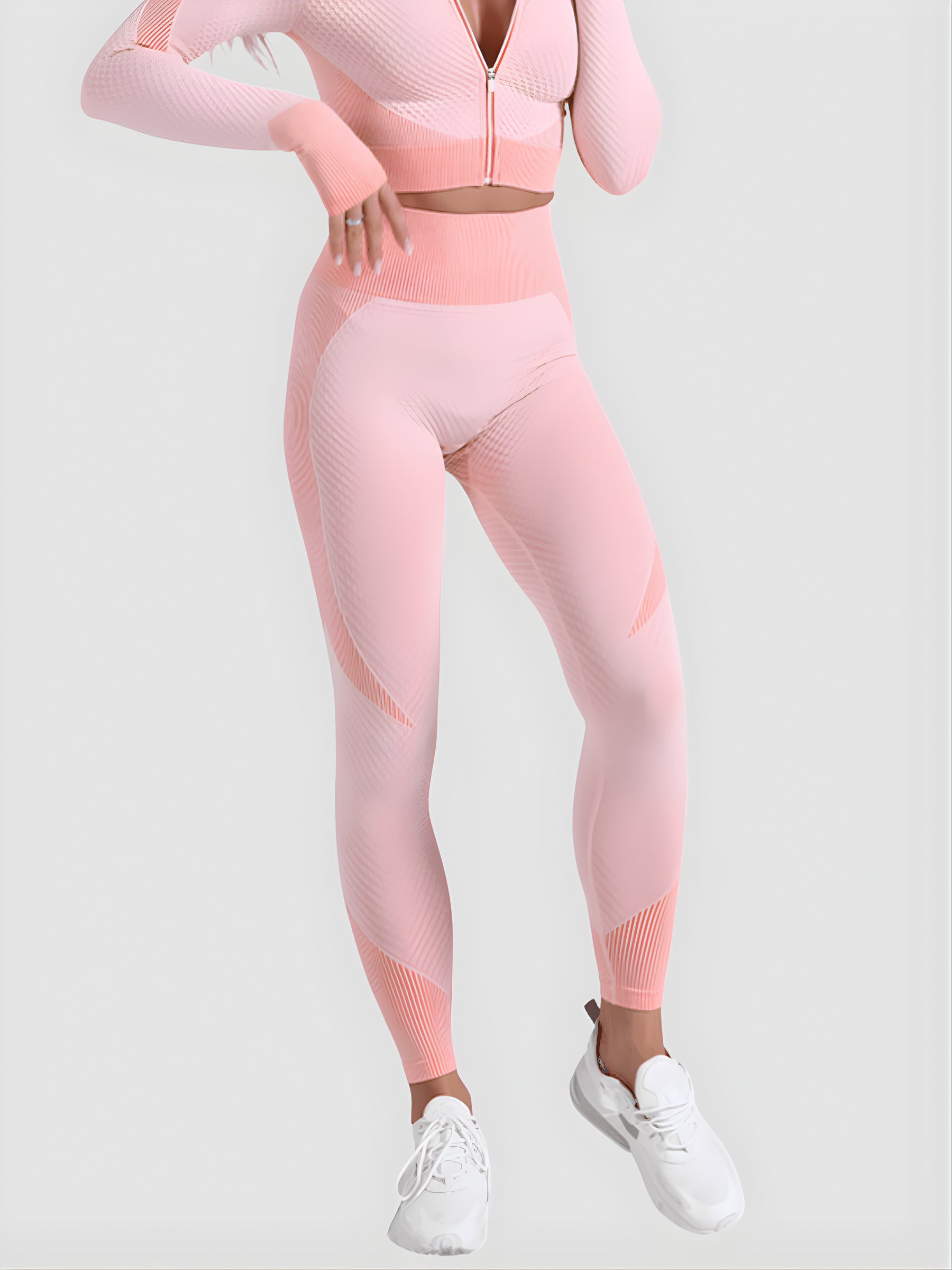 Woman wearing high waisted pink patterned color block leggings with a matching athletic jacket by BodyFlexx.
