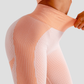 Woman wearing high waisted pink patterned color block leggings with tummy control by BodyFlexx.