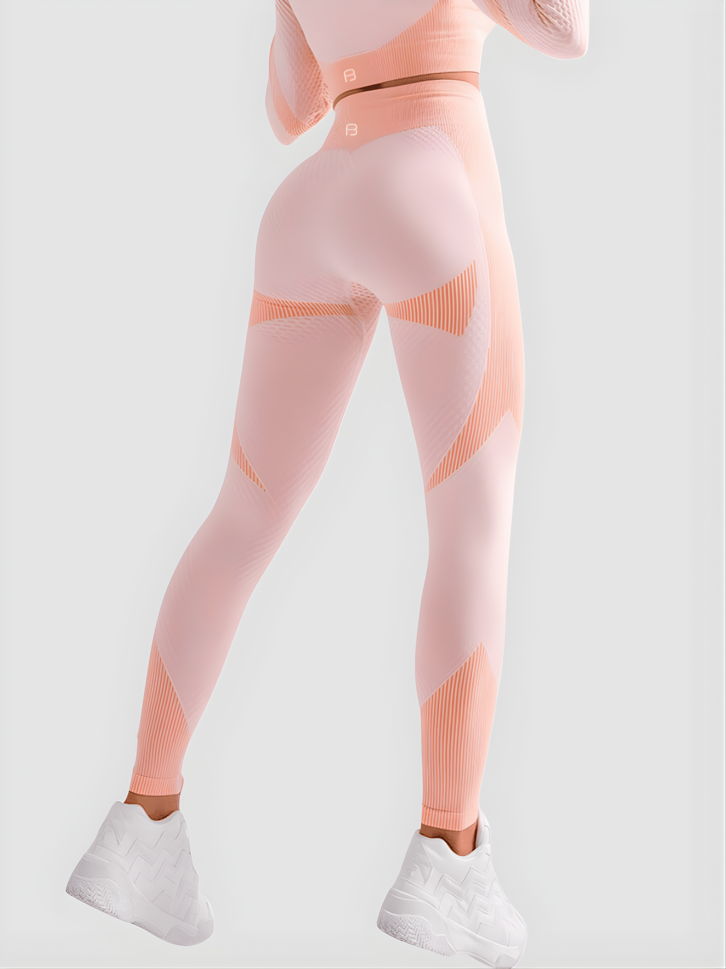 Woman wearing high waisted pink patterned color block tummy-control leggings by BodyFlexx.