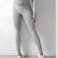 Woman wearing high waisted silver gray leggings that contour her legs and bum designed by BodyFlexx.
