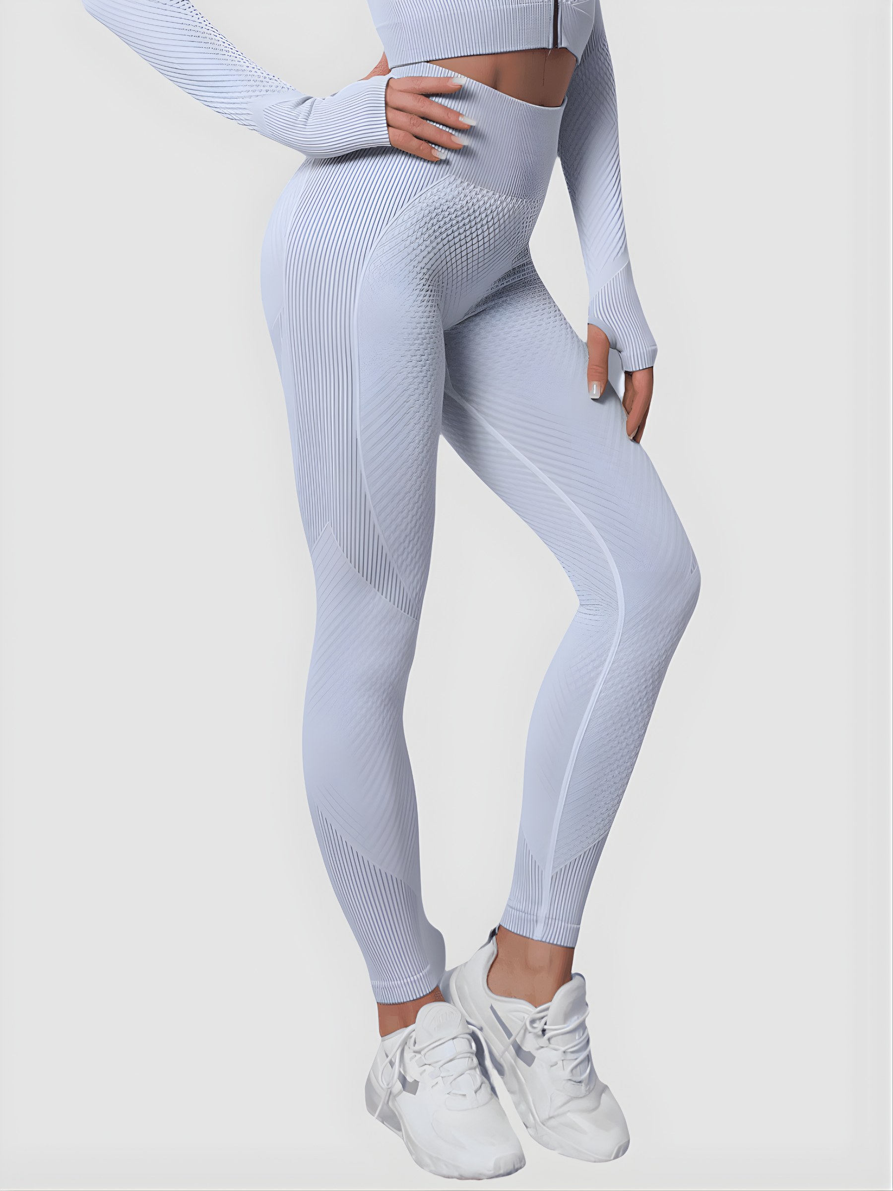Woman wearing high waisted silver gray patterned textured leggings with tummy control by BodyFlexx.