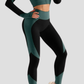 Woman wearing high waisted black and teal patterned color block leggings with a matching activewear jacket by BodyFlexx.