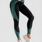 Woman wearing high waisted black and teal patterned color block leggings with tummy control by BodyFlexx.