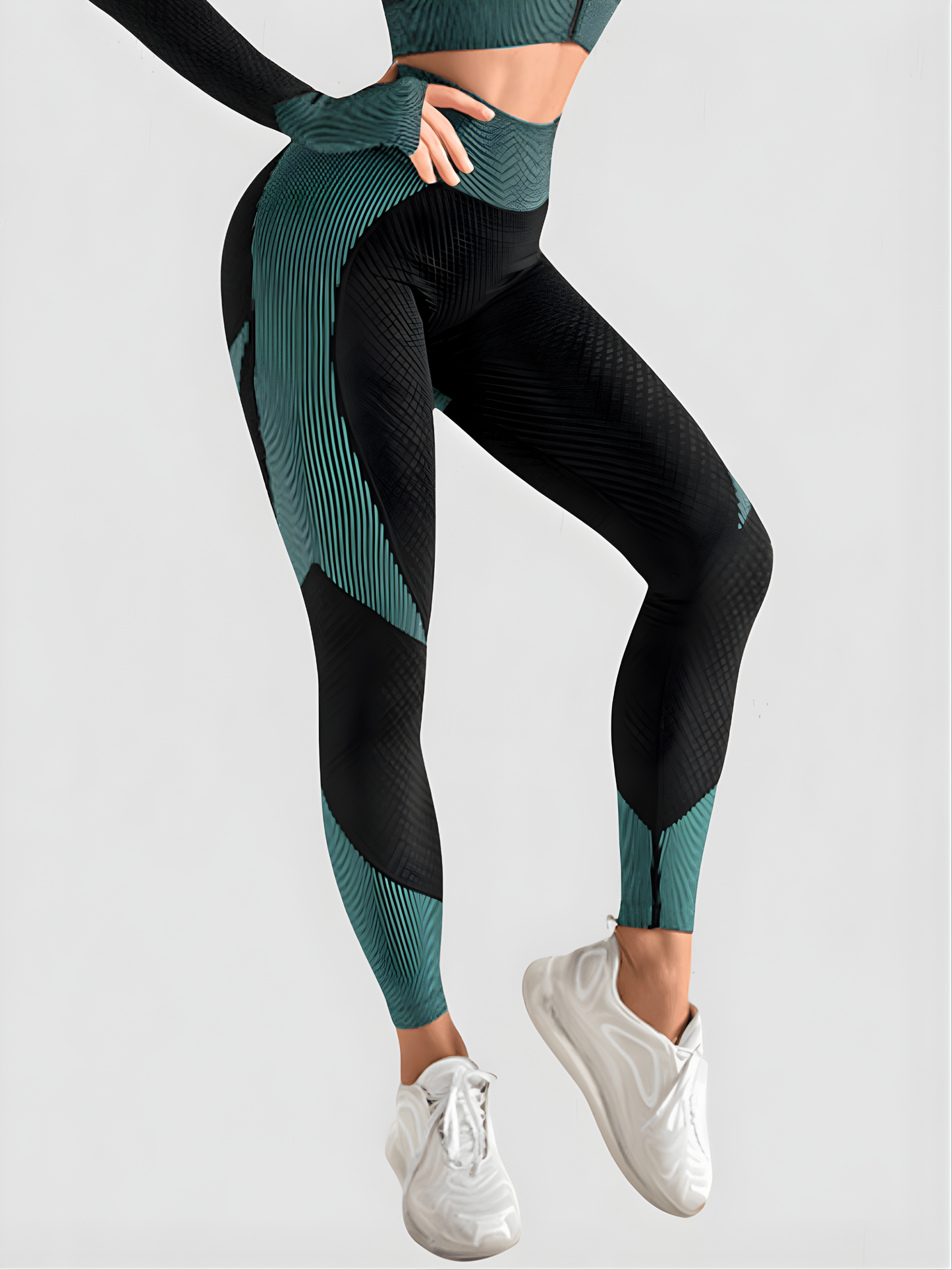 Woman wearing high waisted black and teal patterned color block leggings with tummy control by BodyFlexx.