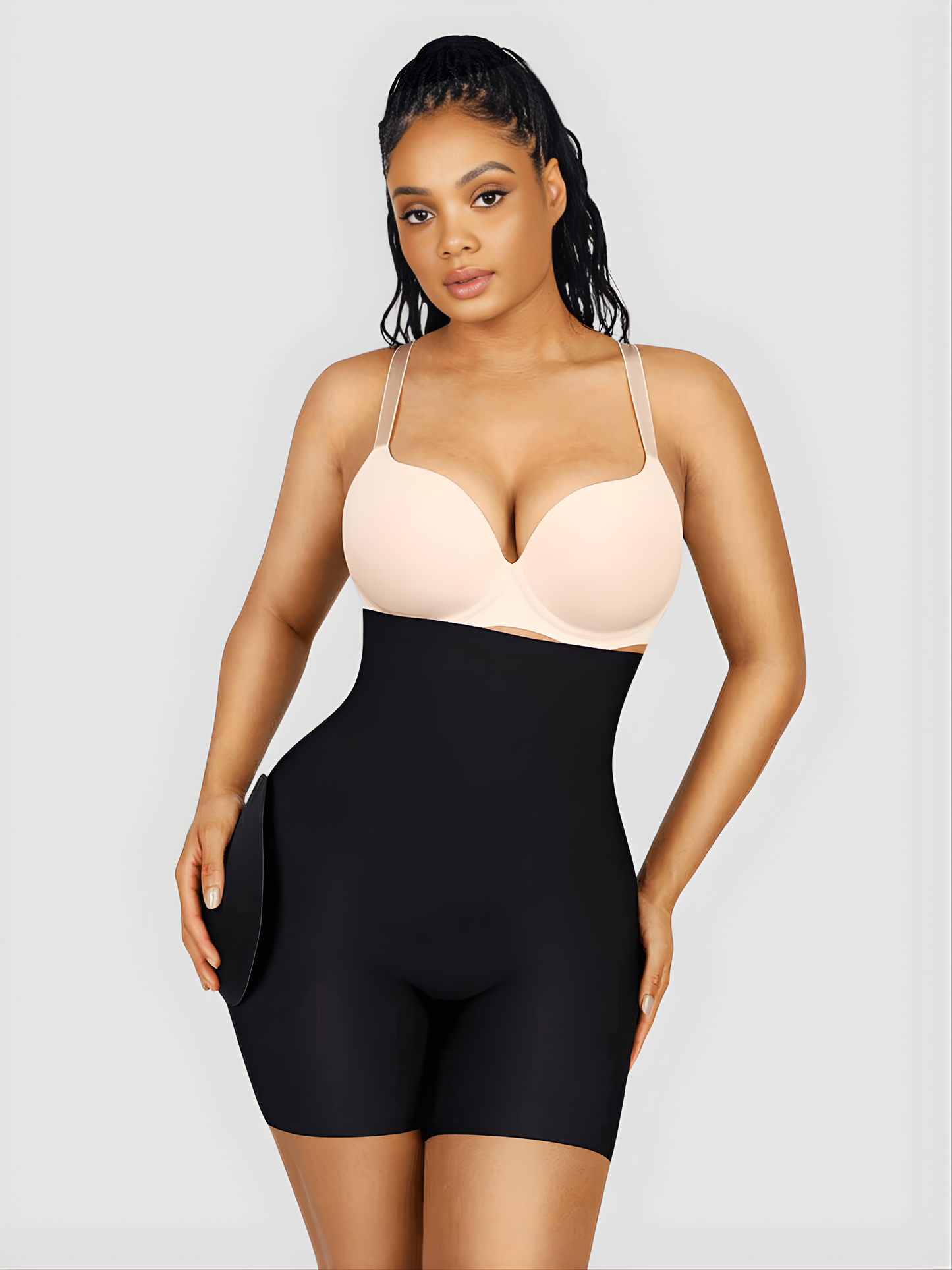 Woman wearing high waisted black shaping bottoms with removable hip pads by BodyFlexx Shapewear.