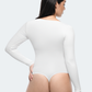 Back view of a woman wearing a white long-sleeve tummy-control thong shapewear bodysuit top by BodyFlexx.