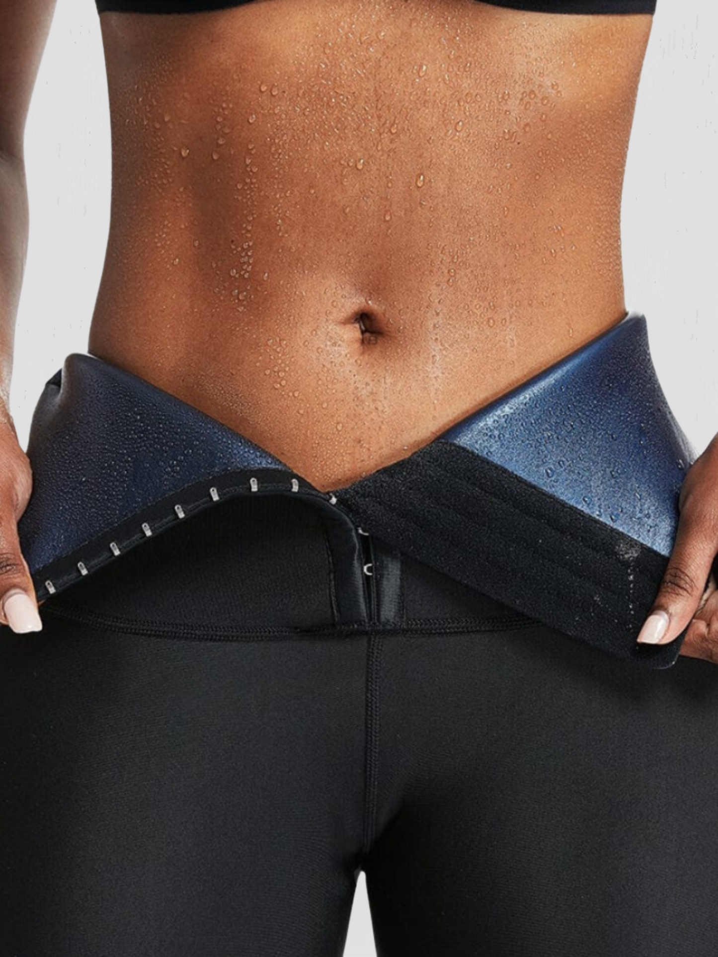 Woman wearing neoprene-lined activewear snorts with a corset closure showing a sweaty stomach after a good workout.