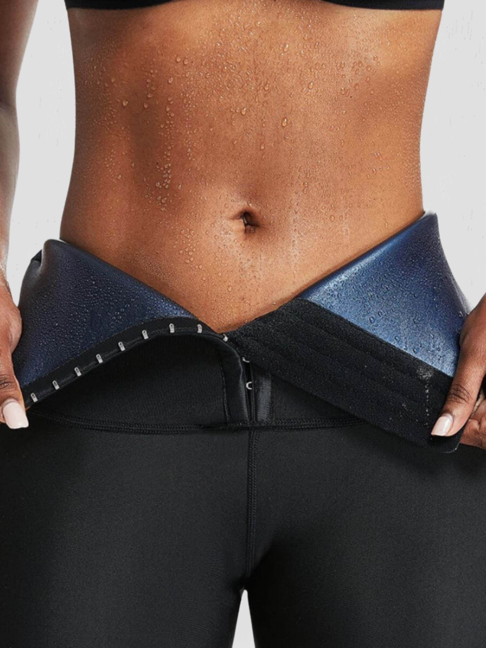 Woman wearing neoprene-lined activewear snorts with a corset closure showing a sweaty stomach after a good workout.