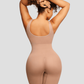 Woman wearing a beige/nude colored mid-thigh shapewear bodysuit showing her backside curves.