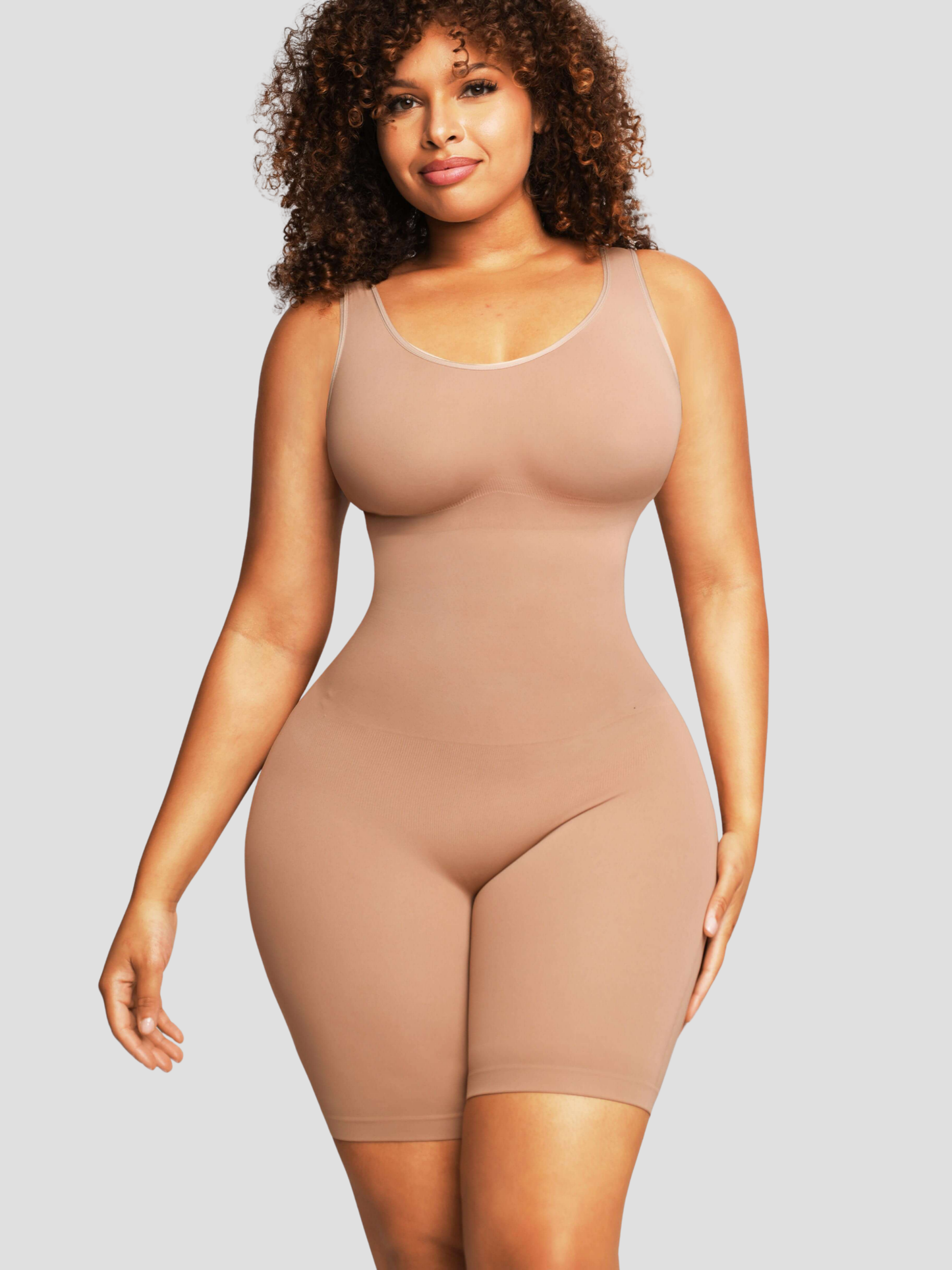 Woman wearing a beige/nude coloured mid-thigh shapewear bodysuit by BodyFlexx.