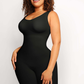 Woman wearing a black mid-thigh shapewear bodysuit designed by BodyFlexx.