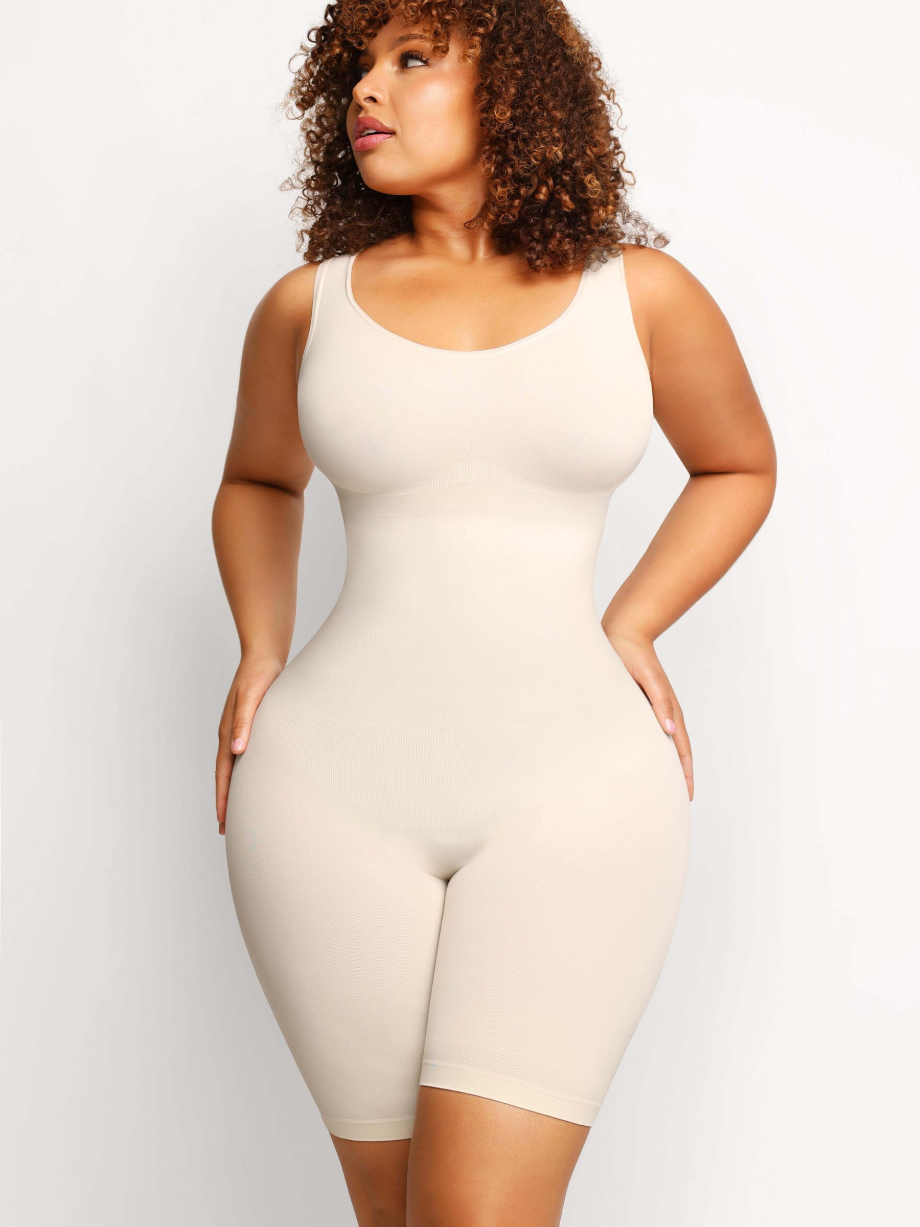Woman wearing an ivory/white colored mid-thigh shapewear bodysuit by BodyFlexx flaunting her beautiful curvy figure.