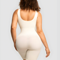 Model wearing an ivory/white colored mid-thigh shapewear bodysuit showing off her cellulite free backside curves.