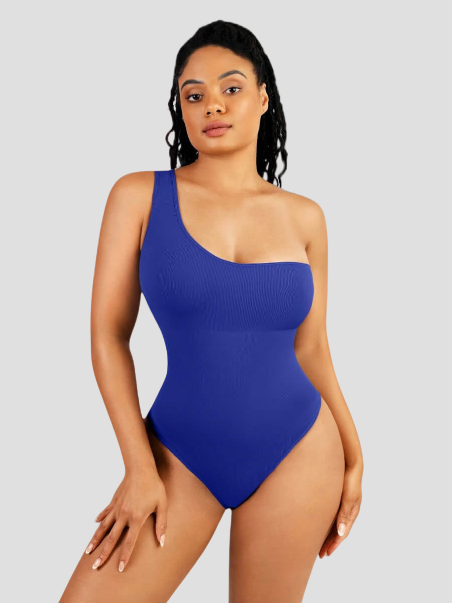 A woman posing wearing a royal blue off-the-shoulder sleeveless shaping bodysuit with built-in tummy-control shapewear.