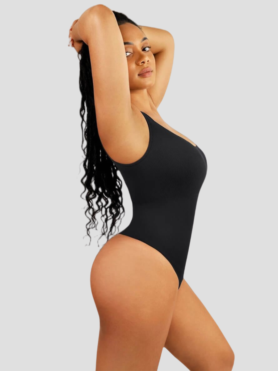 Woman posing wearing a black off-the-shoulder shaping bodysuit with built-in shapewear for tummy-control and hourglass curves.