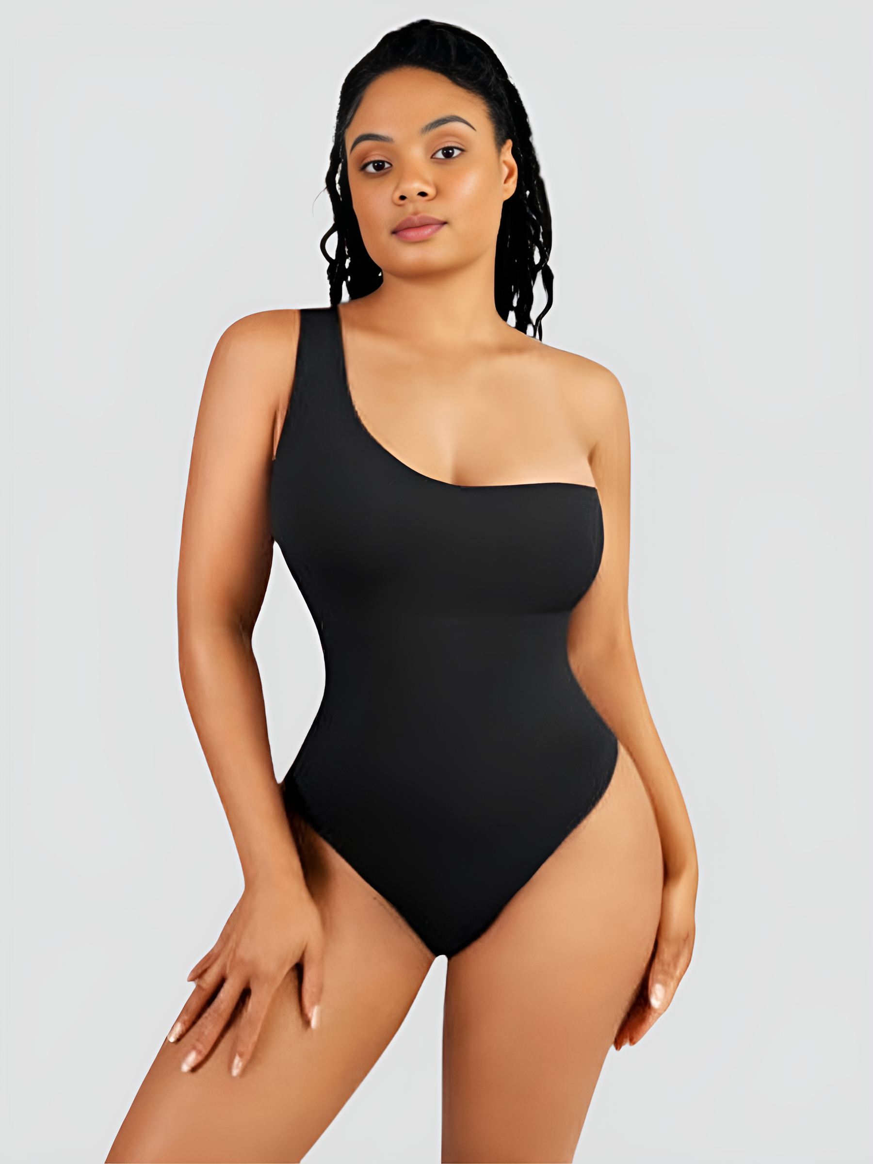 Woman posing wearing a black off-the-shoulder shaping bodysuit with built-in shapewear for tummy-control and hourglass curves.