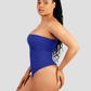 A woman posing wearing a blue off-the-shoulder seamless shaping bodysuit with built-in tummy-control shapewear to show off her curves.
