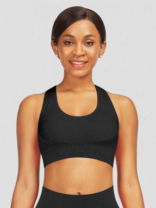 Woman wearing a black textured sports bra by BodyFlexx.