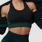 Woman wearing a padded black and teal textured sports bra with matching leggings and activewear jacket by BodyFlexx.
